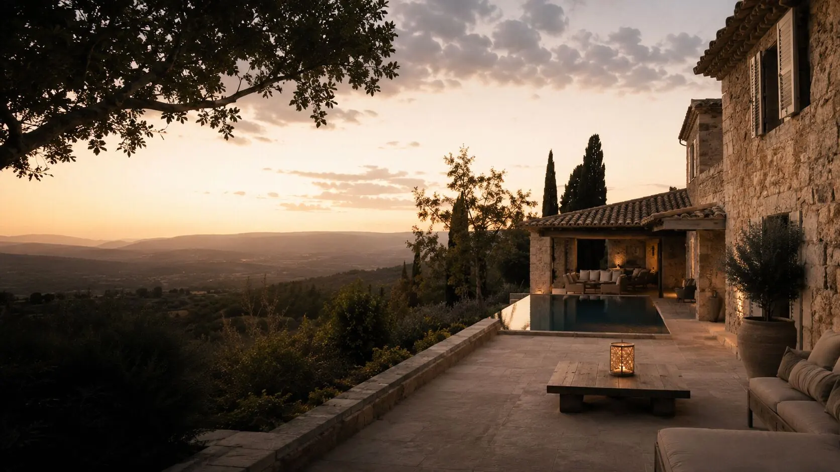 Terrace of a Provence guesthouse at dusk, pool and valley beyond